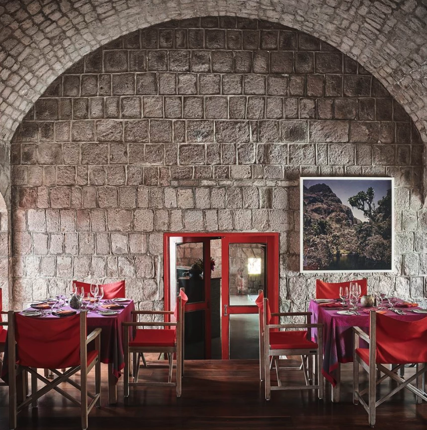 a room with red chairs and tables