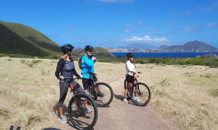 a group of people on bikes on a dirt road