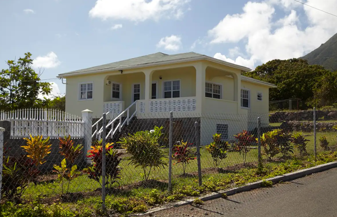 a house with a fence and plants