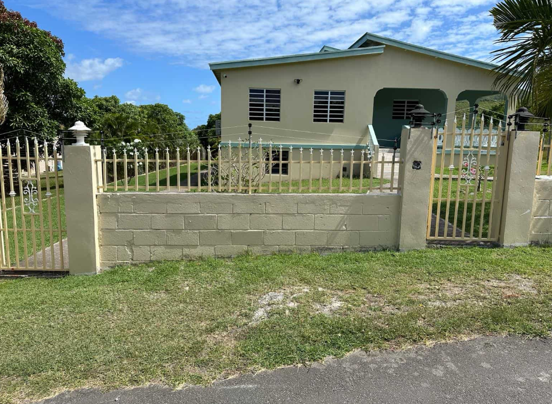 a house with a fence and grass