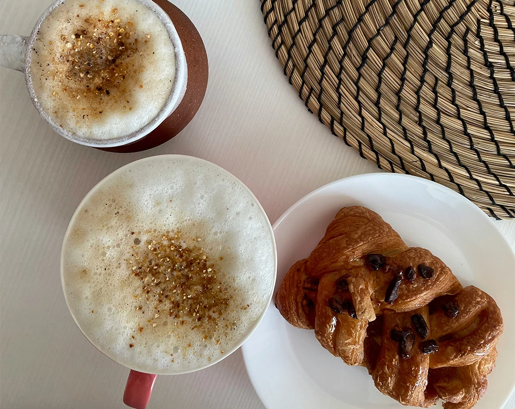 a cup of coffee and a pastry on a plate