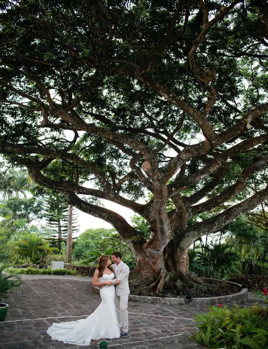 a man and woman standing under a tree