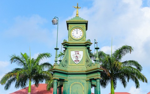 a clock tower with a weather vane