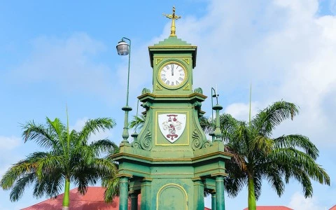 a clock tower with a weather vane