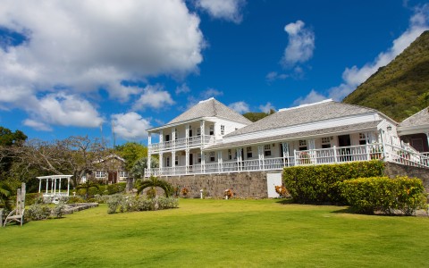 a large white house with a lawn