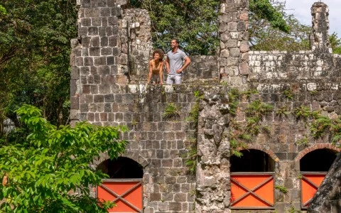 a man and a woman standing on a stone wall