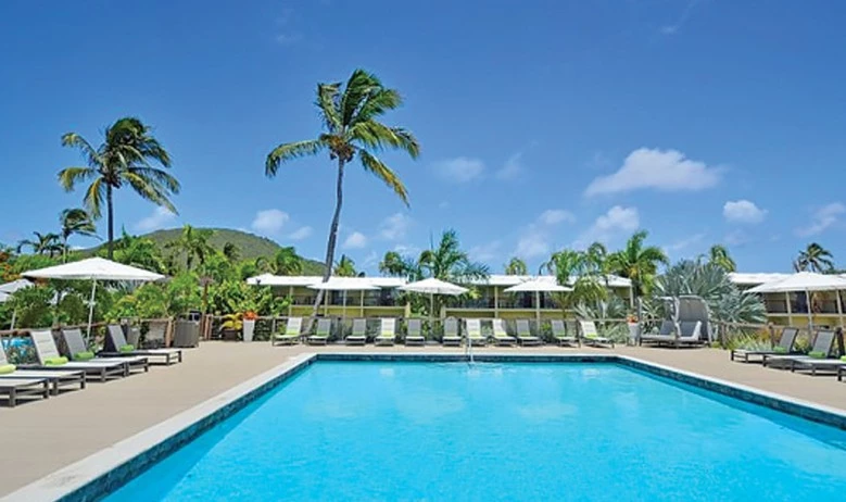 a pool with lounge chairs and umbrellas by it