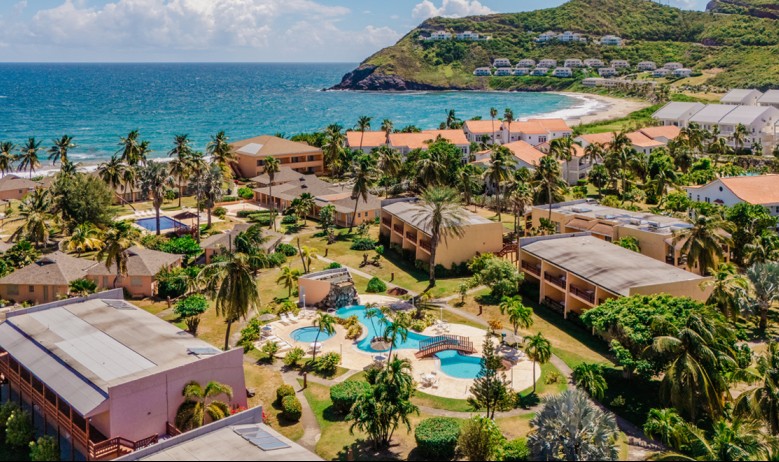 a resort with a pool and a body of water 