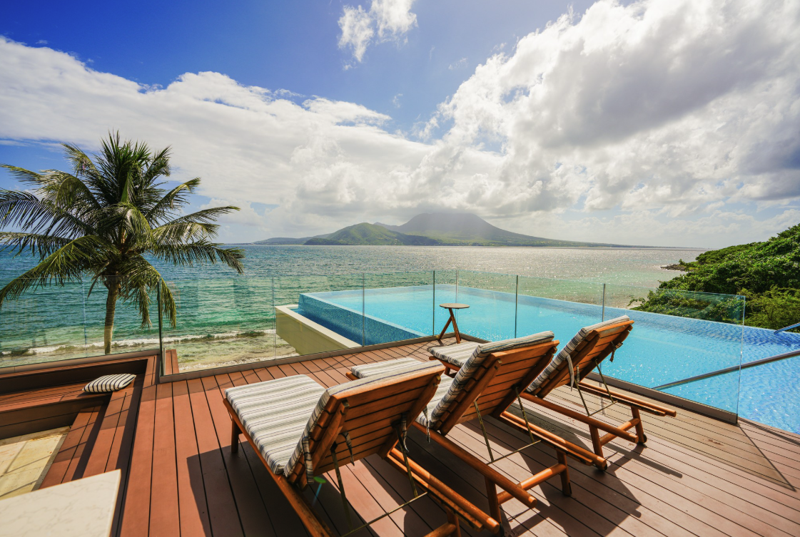 chairs on a deck overlooking a pool