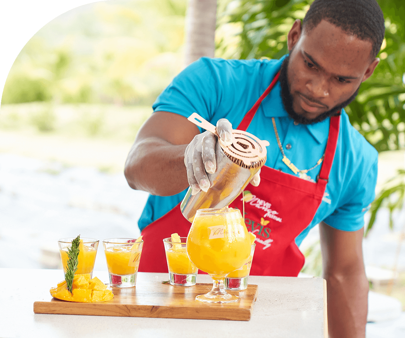 a man pouring a drink into a glass
