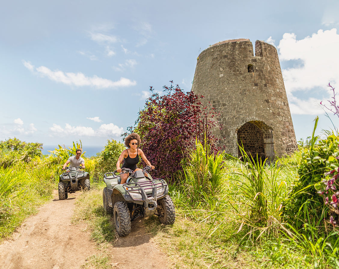a couple people riding atvs