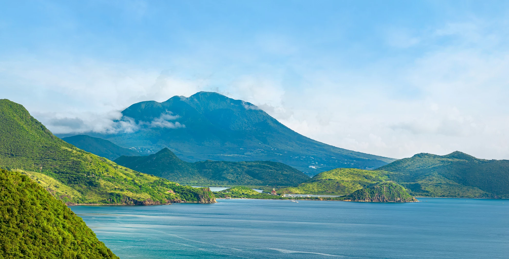 a body of water with a mountain in the background