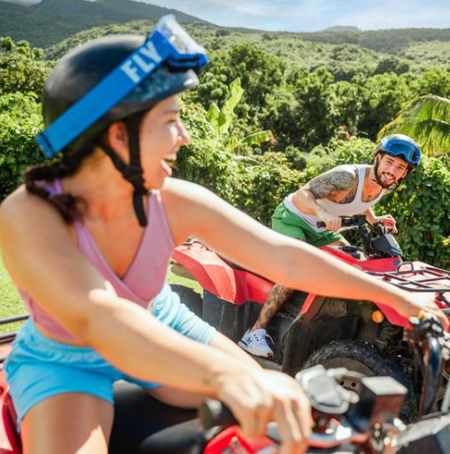 a man and woman on atvs