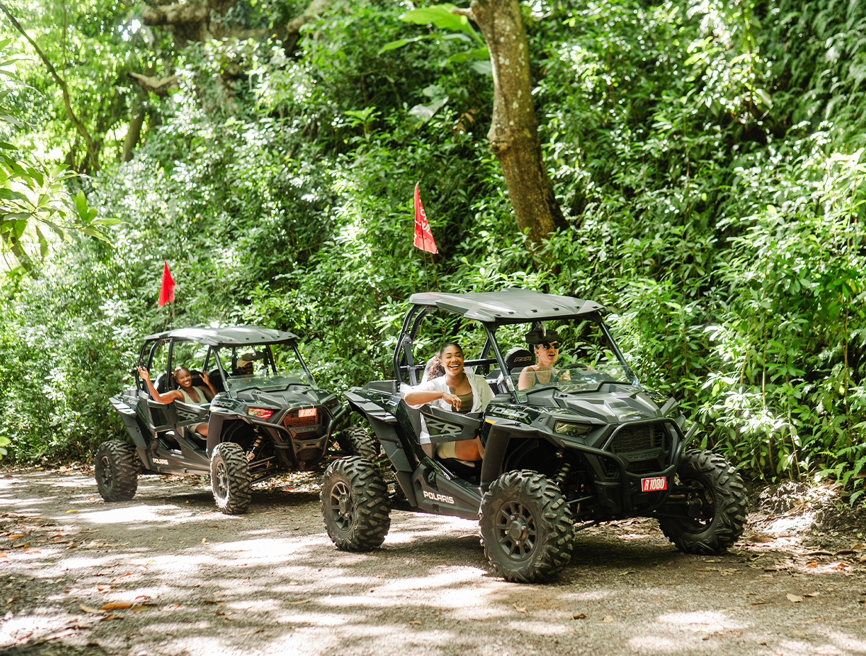 a group of people driving off road vehicles