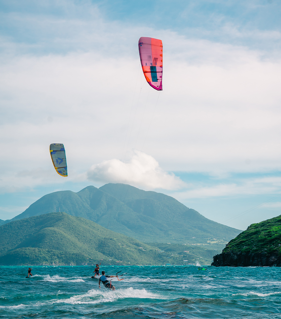 a group of people kite surfing in the ocean