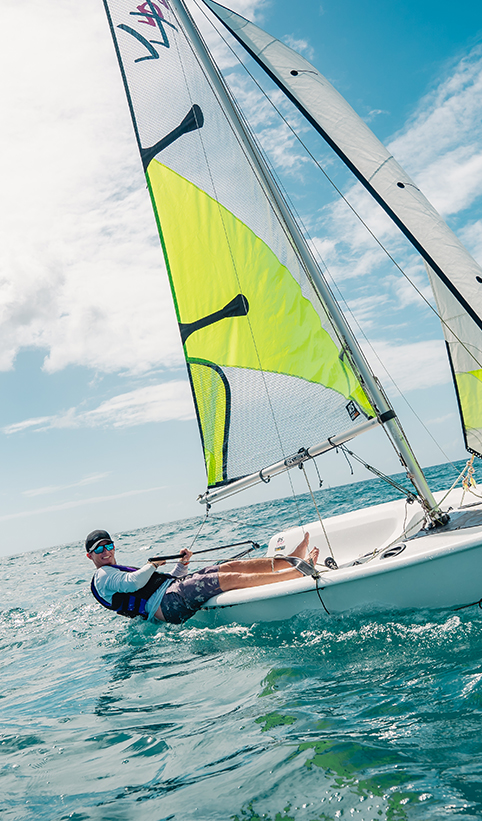 a man lying on a sailboat