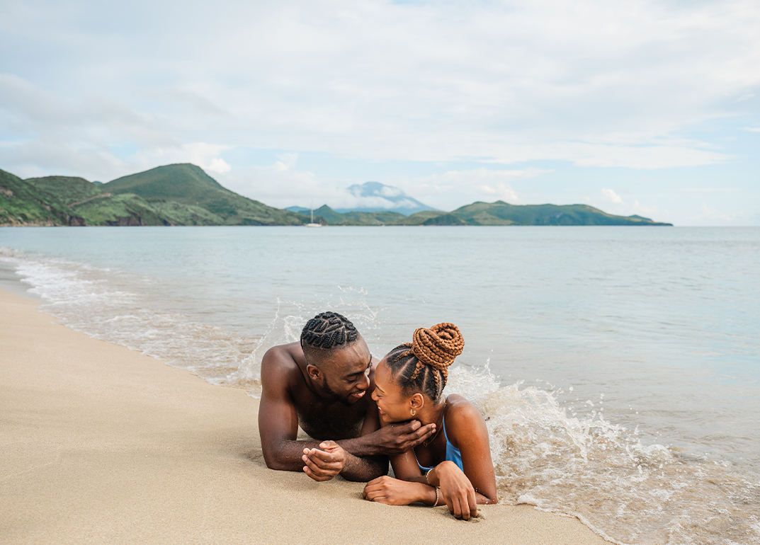 a man and woman lying on the beach
