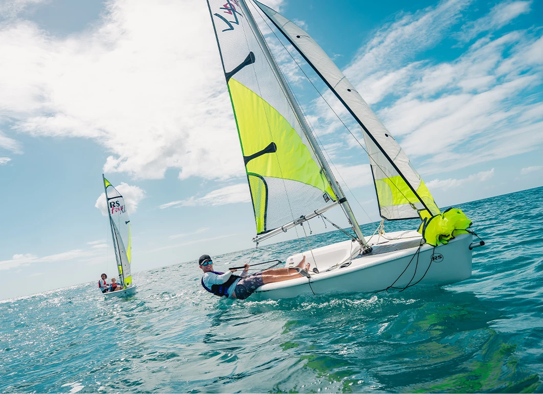 a man in a boat with a sail