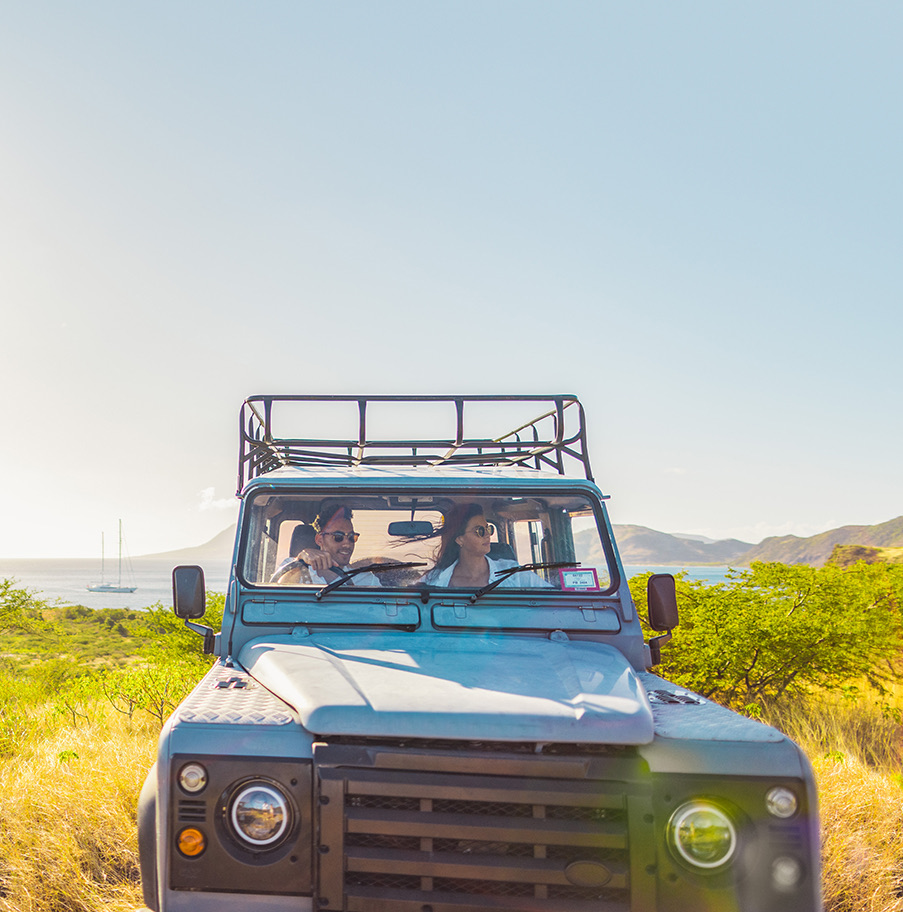 a couple of people in a blue truck in a field