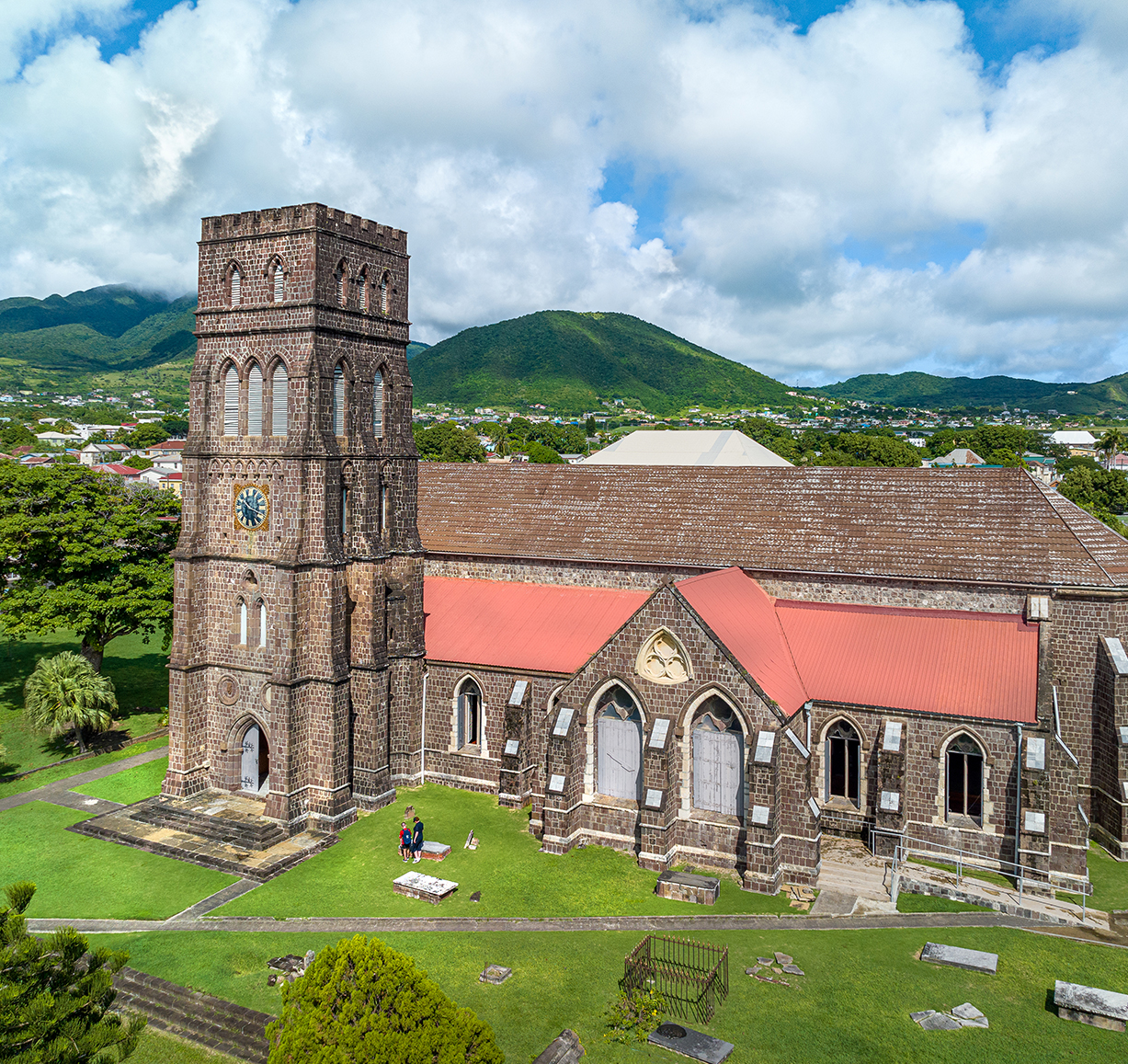 a church with a tower and grass