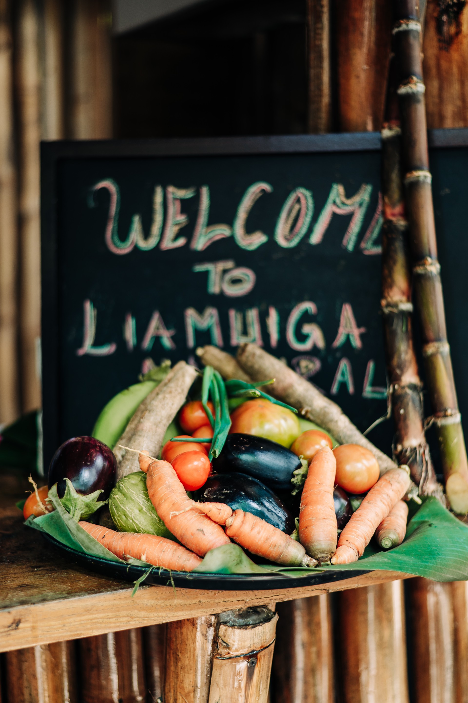 a bowl of vegetables and a sign