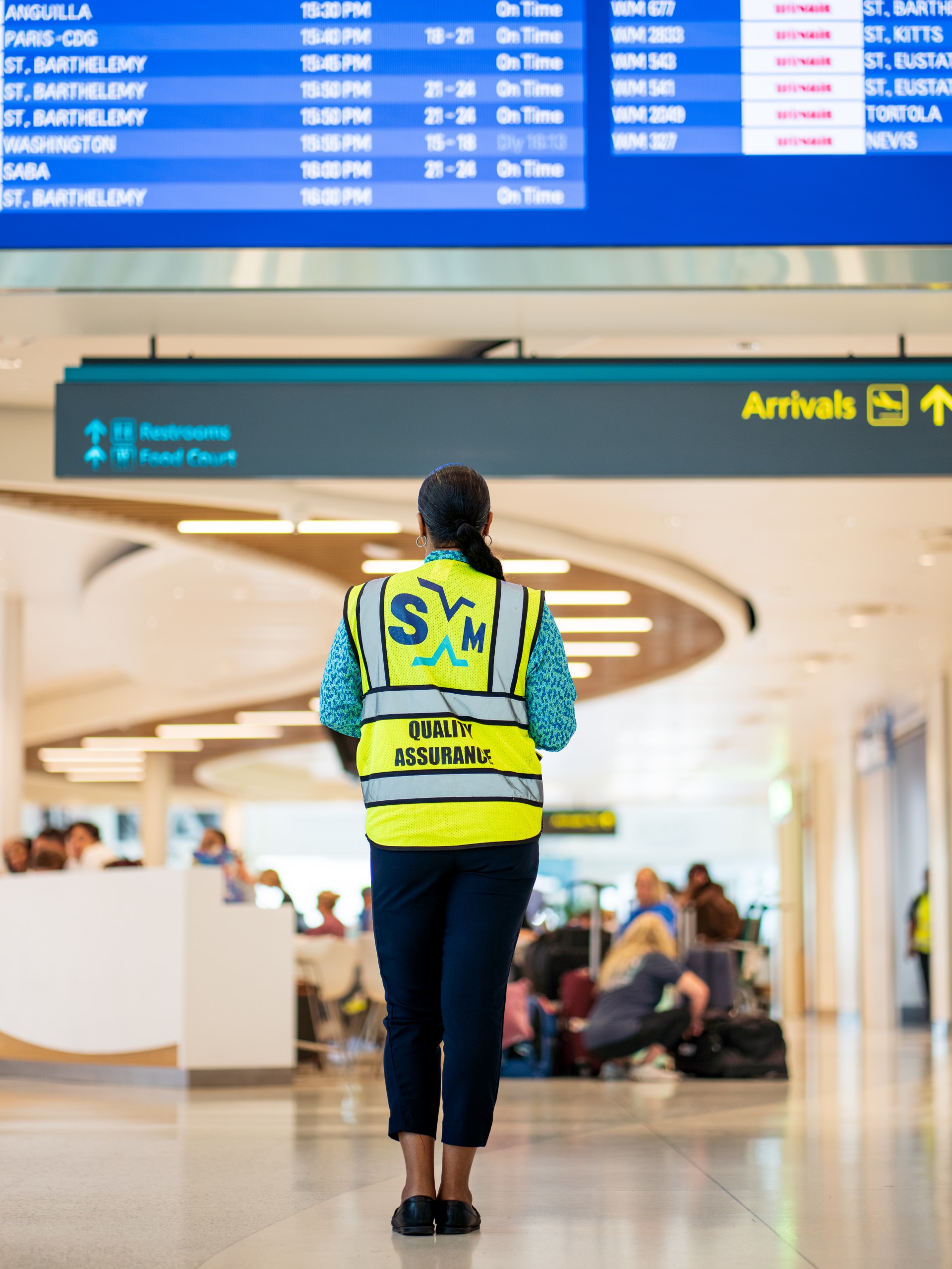a woman in a yellow vest in an airport