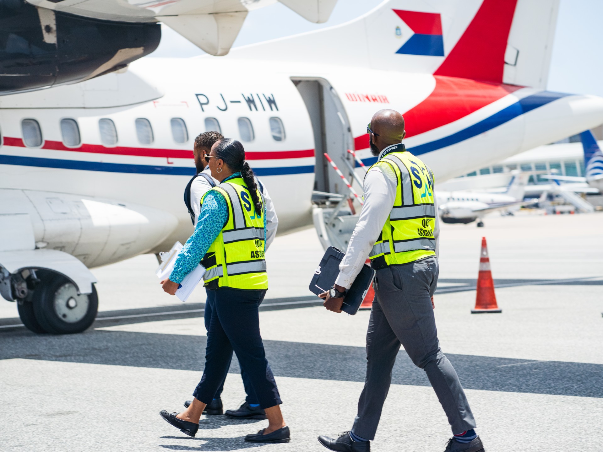 a group of people walking near an airplane