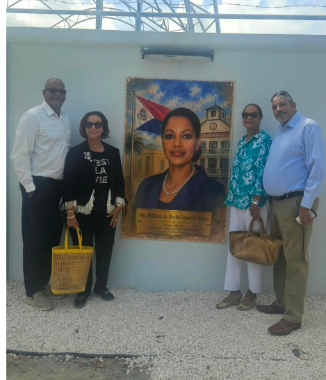 a group of people standing in front of a painting