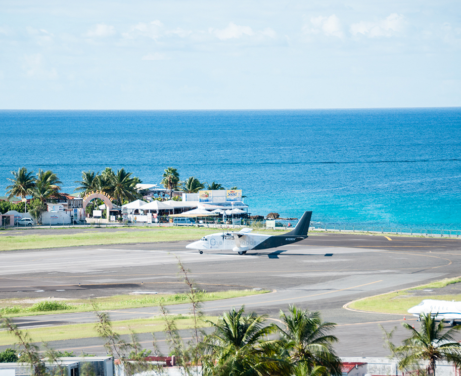 a plane on a runway near the ocean