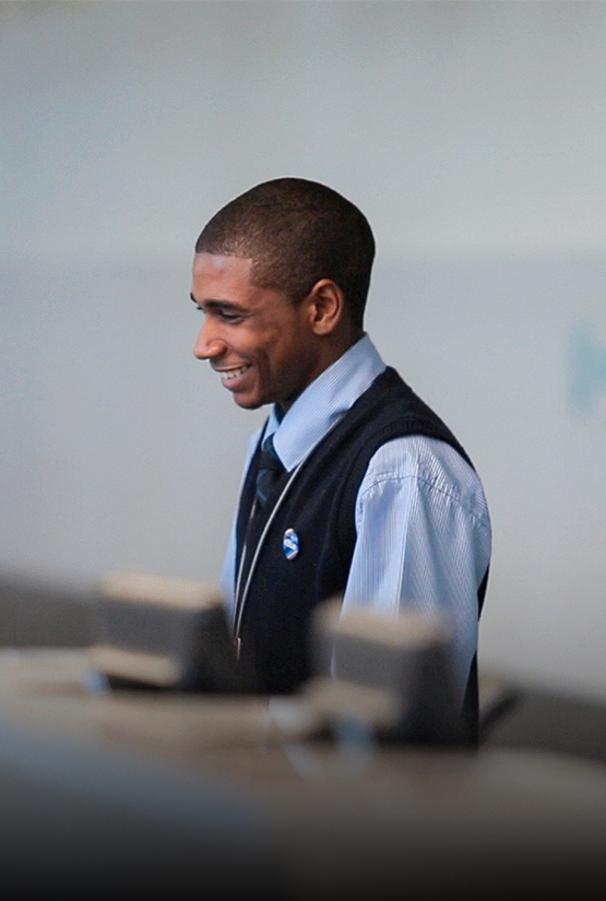 a man in a vest smiling