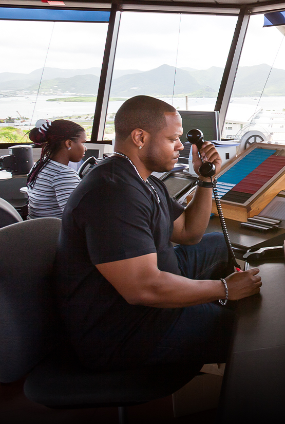 a man holding a telephone in a control room