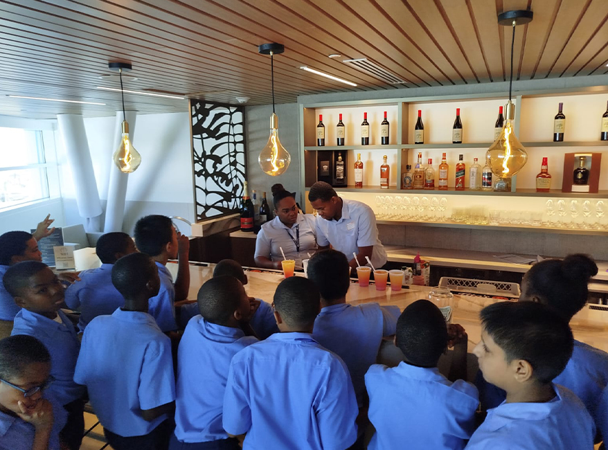 a group of people sitting around a bar