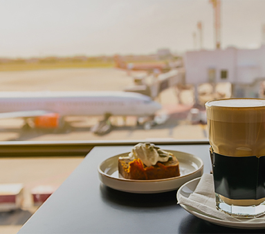a glass of coffee and a plate of food