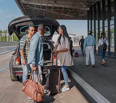 a group of people standing next to a car