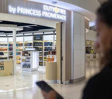 a person holding a phone in front of a store