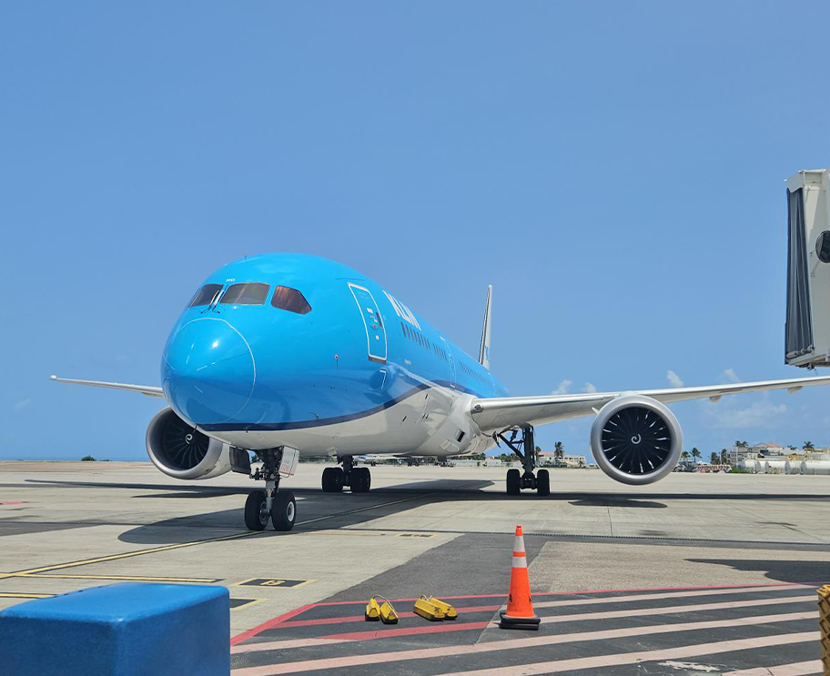a blue and white airplane on a runway