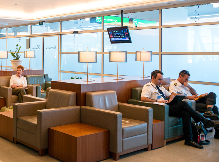 a group of men sitting in chairs in a lounge