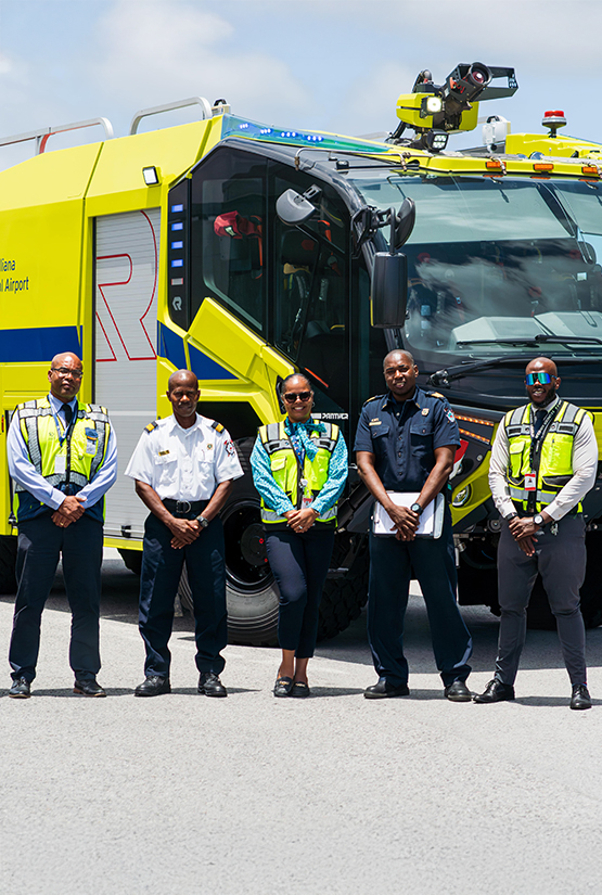 a group of people standing in front of a yellow truck
