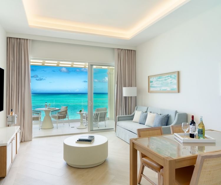 a living room with a glass door and a table and chairs