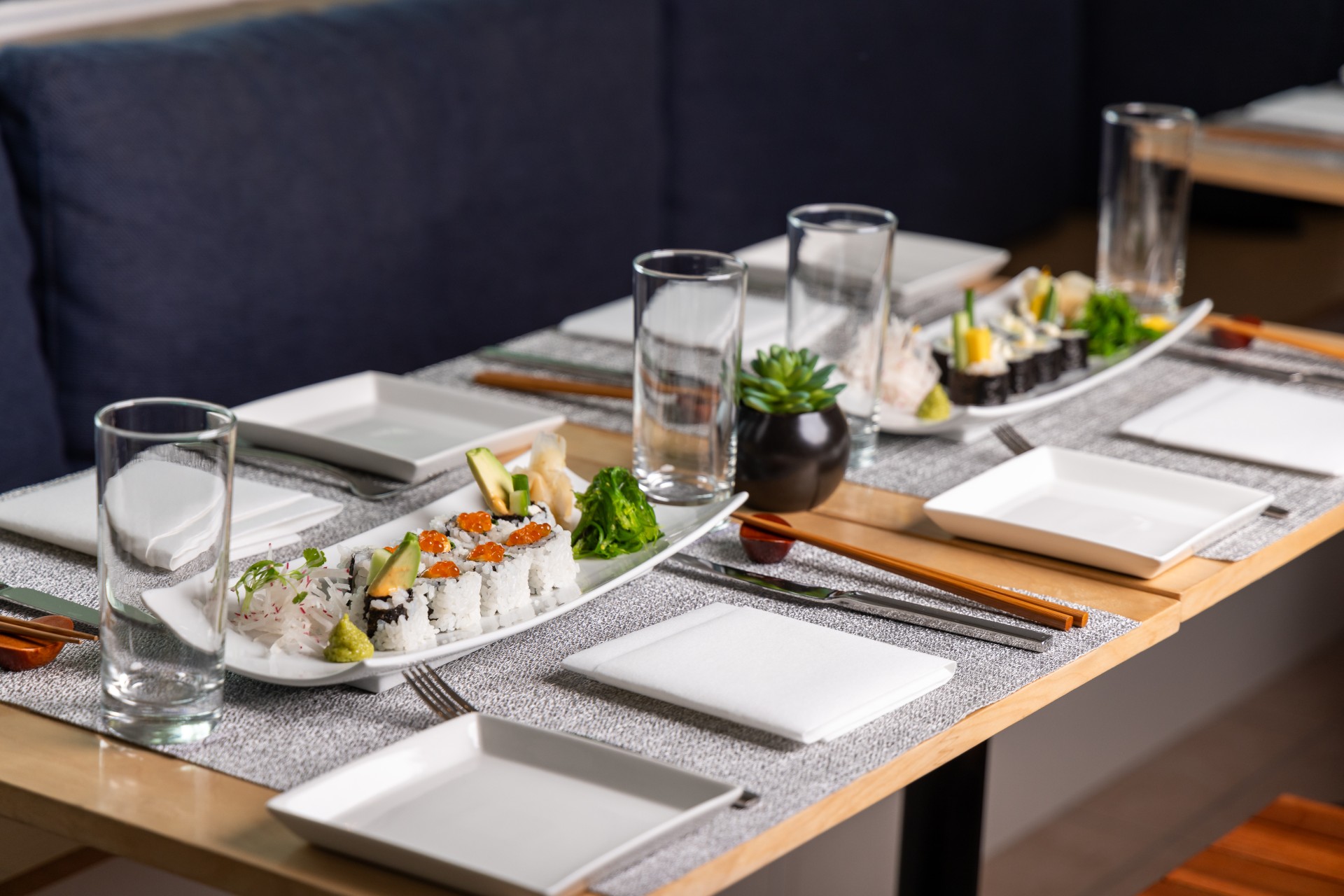 a table with plates and plates and sushi
