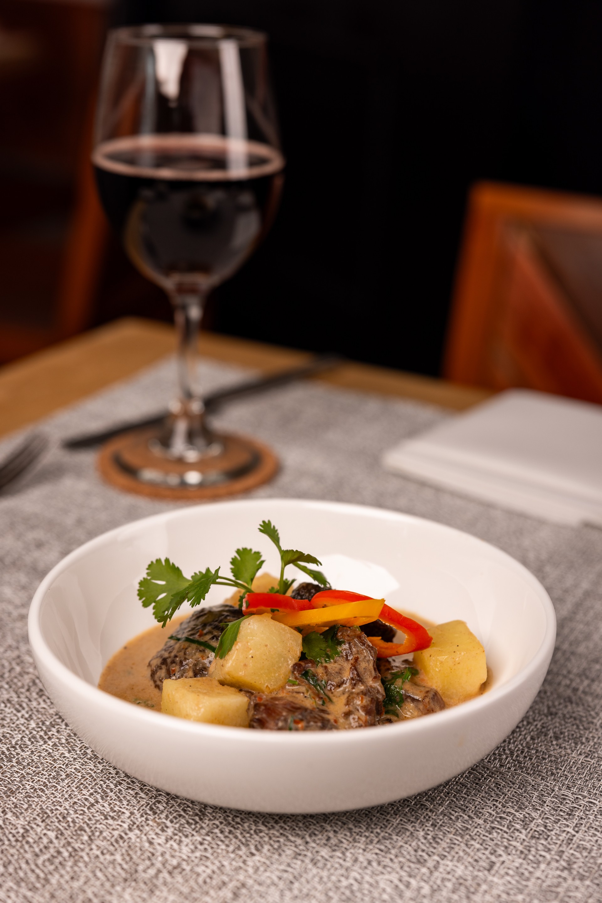 a bowl of food and a glass of wine