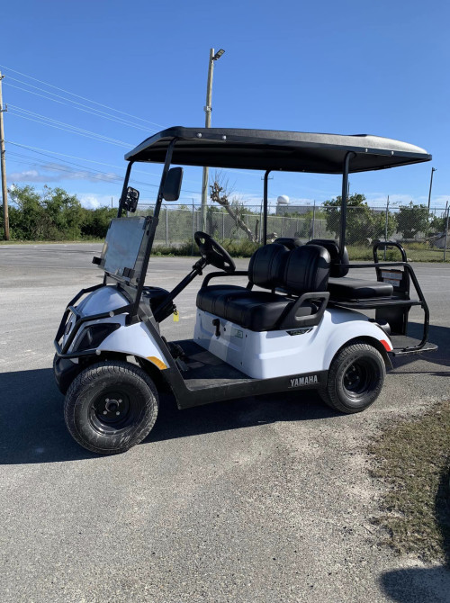 a golf cart parked on a road