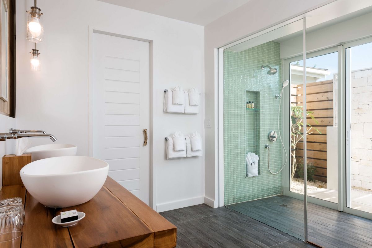 a bathroom with a glass shower door and sink