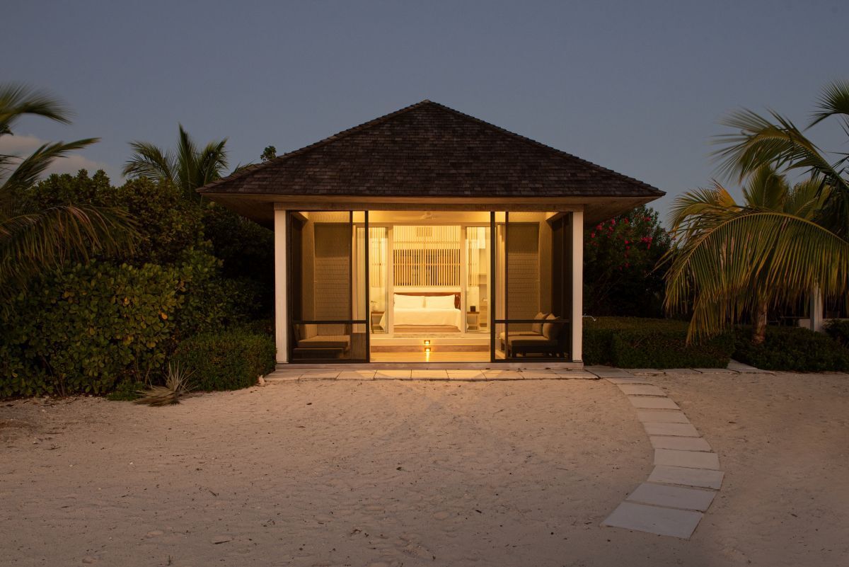 a small house with a bed and a candle in the front