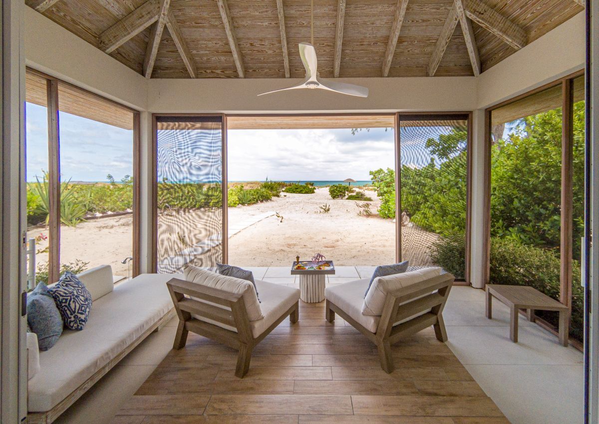 a room with a view of the beach and a table