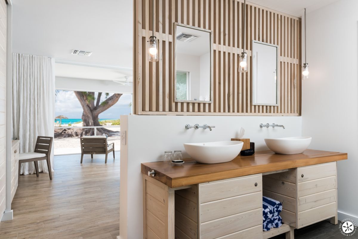 a bathroom with double sinks and mirrors