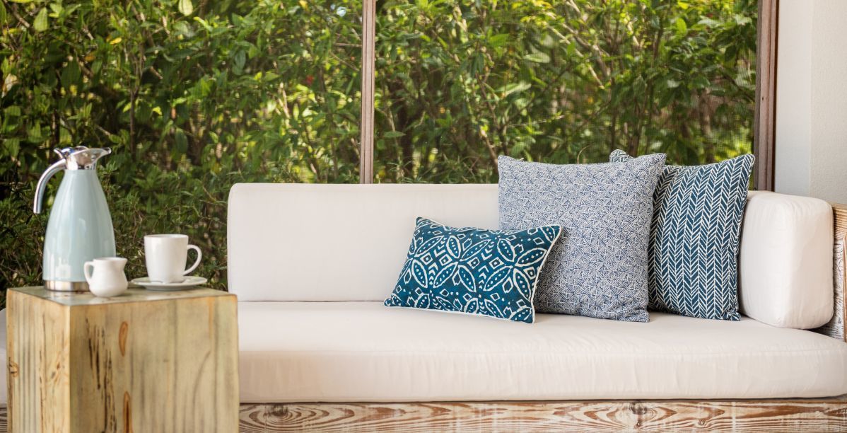 a white couch with blue pillows