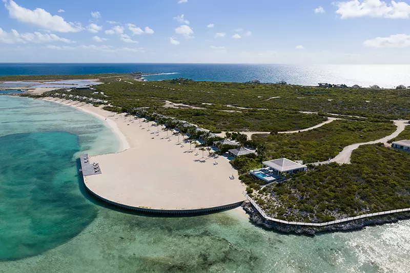 an island with a beach and a pool