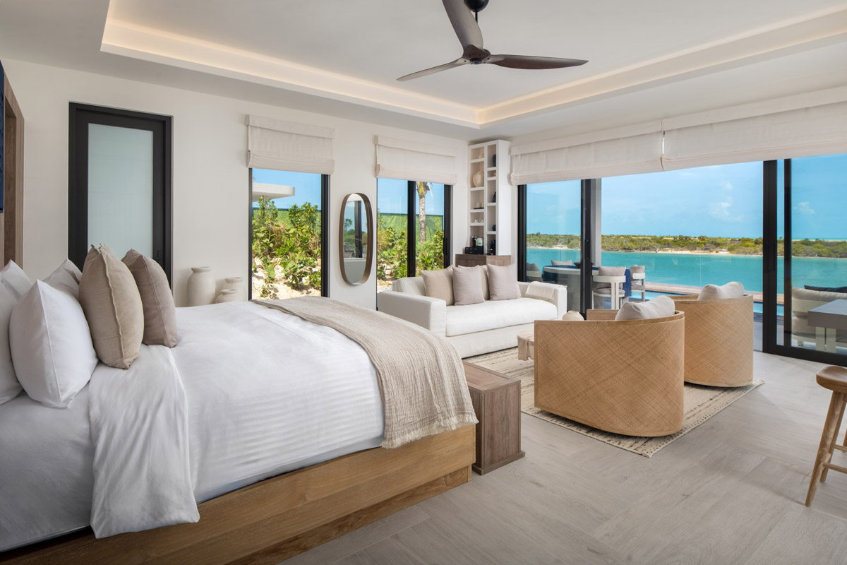 a room with a bed and a couch and a pool