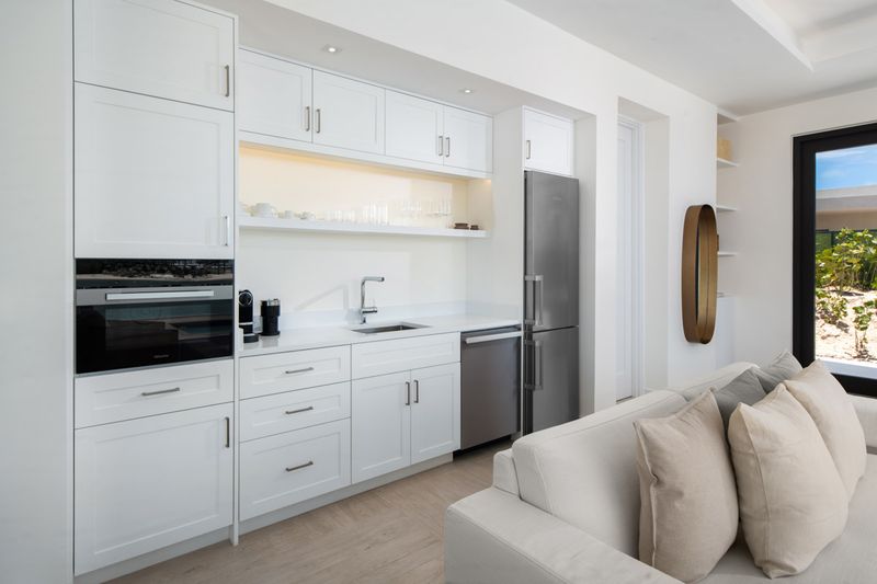 a kitchen with white cabinets and a couch